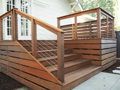 a wooden stair case next to a white house