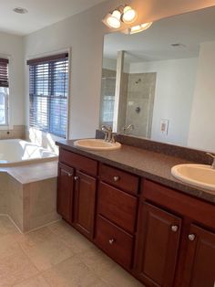 a large bathroom with two sinks and a bathtub