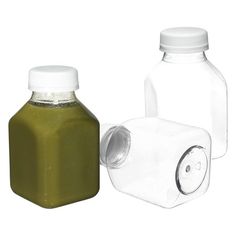 two plastic bottles with lids are next to each other on a white background, one is empty and the other has a green liquid in it