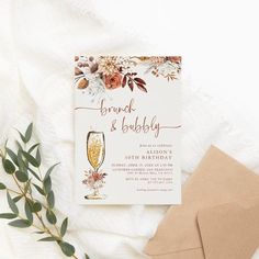 an elegant bridal and baby shower party with wine glasses, greenery and envelope