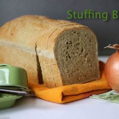 a loaf of bread sitting on top of a cutting board next to an onion slice