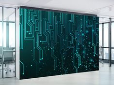 an office with a large green wall covered in circuit boards