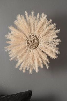 a wall hanging made out of dried grass