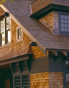 a brown house with wooden shingles and windows