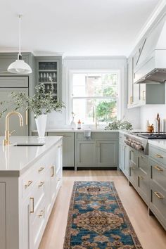 a kitchen with an area rug in front of the counter and cabinets on both sides