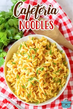 a bowl filled with pasta and parsley on top of a checkered table cloth