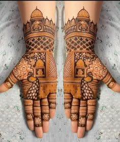 two hands with henna designs on them, one is showing the intricate design and the other has ornate details