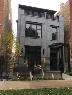 a black and grey house with lots of windows