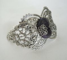 "This beautiful silver plated filigree cuff bracelet has a silver plated triple moon design, amethyst setting with silver plated embellishments and silver plated chain. 6\" long adjustable to 9\" long. Silver plated lobster clasp." Dragons Breath Fire Opal, Wicca Jewelry, Goddess Bracelet, Triple Moon Goddess, Amethyst Set, Jewelry Gothic, Goddess Jewelry, Moon Bracelet, Wiccan Jewelry