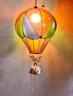 a multicolored hot air balloon hanging from a ceiling