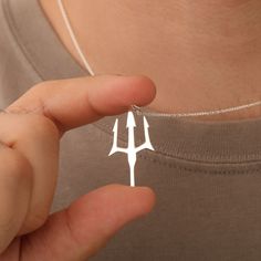 This striking silver trident necklace is an ideal gift for any man who loves the ocean or mythology. Inspired by Poseidon's iconic trident, it makes a meaningful and stylish present for Christmas or birthdays 🎄🎁. High-quality silver trident pendant representing strength and the sea 🌊 Ideal Christmas or birthday gift for ocean lovers Lightweight and comfortable, perfect for daily wear Minimalist design suitable for all occasions Adjustable chain length to fit your style preferences A great way Poseidon Symbol, Trident Necklace, Unique Christmas Gift, Nautical Jewelry, Necklace For Men, Jewelry Unique, Unique Christmas Gifts, Ocean Inspiration, Gold Plated Necklace