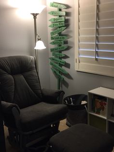 a chair and ottoman in a room with signs on the wall