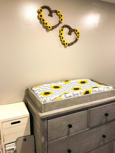 a baby crib with sunflowers on it and the word love spelled in large letters