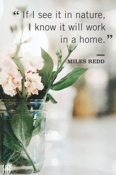 a mason jar filled with pink flowers on top of a white countertop next to a quote from miles reed