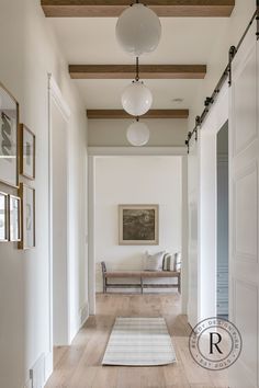 the hallway is clean and ready for guests to use it as an entrance way in this home