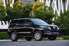 a black suv is parked on the street