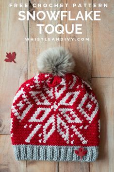 a red and white knitted hat with a pom - pom on top