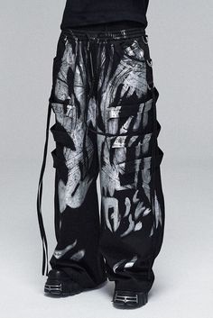 The Multi-Layered Striped Graffiti Cargo Pants are an exceptional piece, embodying a wild and expansive style. These wide-leg pants are adorned with a graffiti-style paintbrush effect throughout, creating a vibrant and artistic appearance. The intricate design is further enhanced by meticulous spliced and strap detailing, adding depth and a tactile dimension to the garment. An elastic waistband ensures a comfortable and adjustable fit, making these pants suitable for a variety of body types. The Five Below Skull Pants, Skelatin Pants, Cheap Trendy Acid Wash Bottoms, Cheap Rave Style Party Bottoms, Luxury Trendy Pants For Streetwear, Luxury Modern Bottoms For Streetwear, Customized Mens Pants, Luxury Distressed Pants For Streetwear, Luxury Biker Bottoms For Streetwear