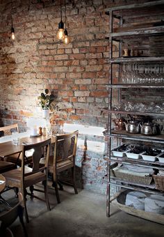 a dining room with brick walls and tables