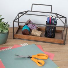 a pair of scissors sitting on top of a table next to some crafting supplies