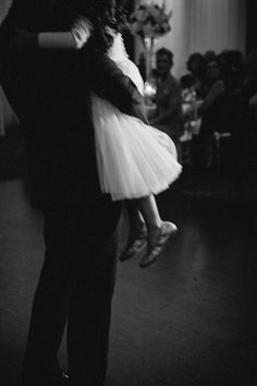 a man and woman are dancing together on the dance floor