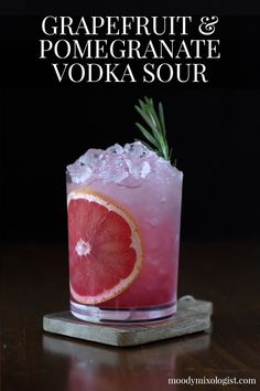 grapefruit and pomegranate vodka sour cocktail with rosemary garnish