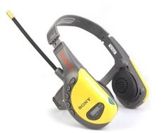 the sony walkie talkie is yellow and gray with a black cord attached to it