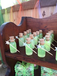 there are many green bottles with toothpicks in them sitting on a wooden shelf