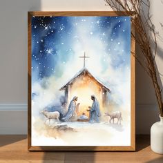 a watercolor painting of the birth of jesus with two sheep and a manger scene