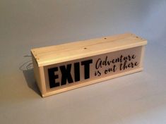 a wooden sign that says, exit adventure is out there