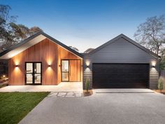 a house with two garages and lights on it