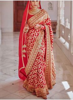 a woman in a red and gold bridal gown