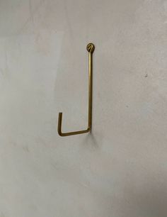 a metal hook is hanging on the wall