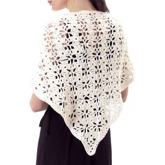 a woman wearing a white crochet shawl and black dress with her back turned to the camera