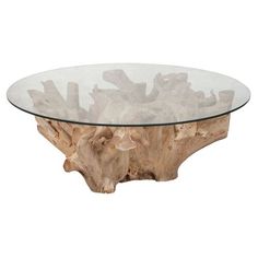 a glass and wood coffee table sitting on top of a white floor