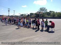 a group of people standing in a parking lot next to each other with their hands together