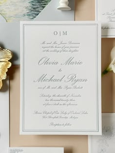 the wedding stationery is laid out on top of each other, including an envelope