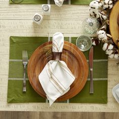 a table set with plates, napkins and silverware