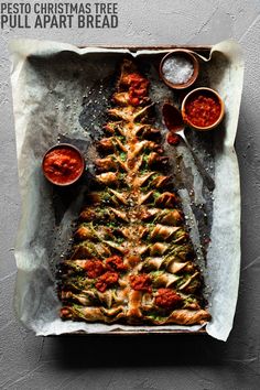 a christmas tree made out of bread and sauces