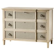 a white dresser with many drawers and knobs