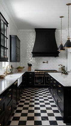 a black and white checkered floor in a kitchen with an oven hood over the range