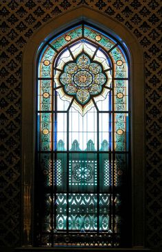 an ornate stained glass window in a building