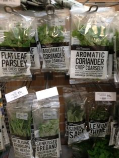 several bags of lettuce on display in a store