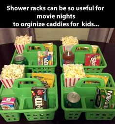 four green baskets filled with movie snacks and sodas on top of a black table