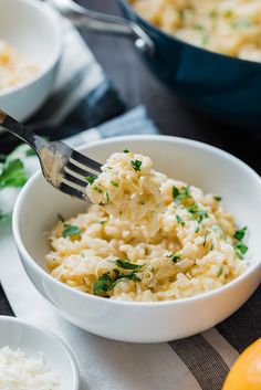 a fork in a bowl filled with macaroni and cheese next to other dishes