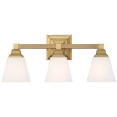 three light bathroom fixture with white glass shades on an aged brass finish and matte opal shade