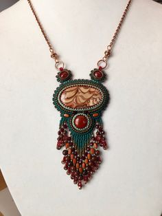 a necklace with beads and beading on a mannequin neckpiece, featuring a woman's face