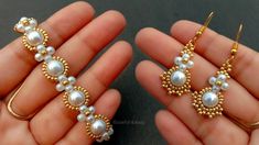 two pairs of gold and pearl earrings in the palm of someone's left hand