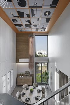 a dining room with a table and chairs in front of a large window overlooking the city