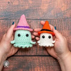 two crocheted amigurt dolls with hats on their heads, one holding the other